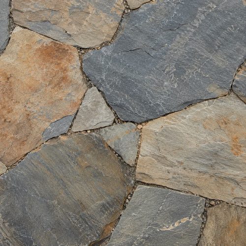 Close-up of a natural stone patio surface with varied color